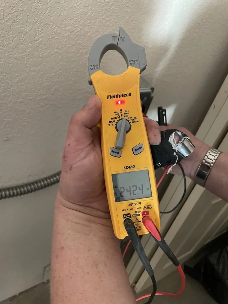 Voltage testing with clamp meter during Whole House Surge Protector in Prairie Grove